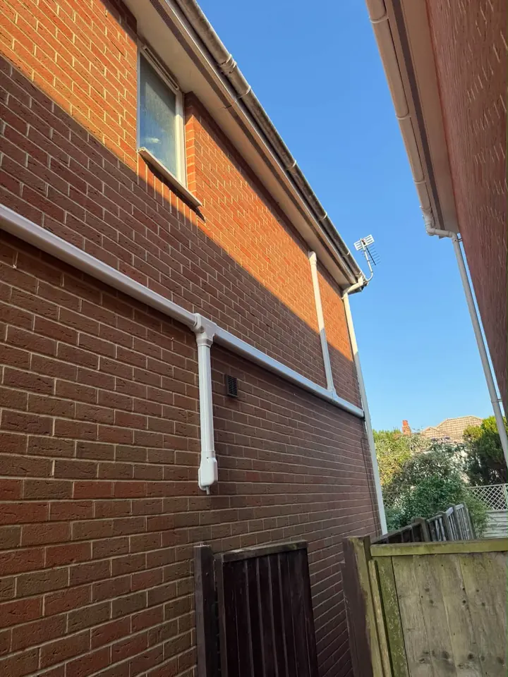 Neatly routed air conditioning pipework on a brick property