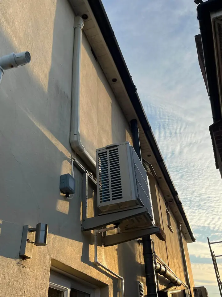 Outdoor air conditioning unit mounted on an exterior wall